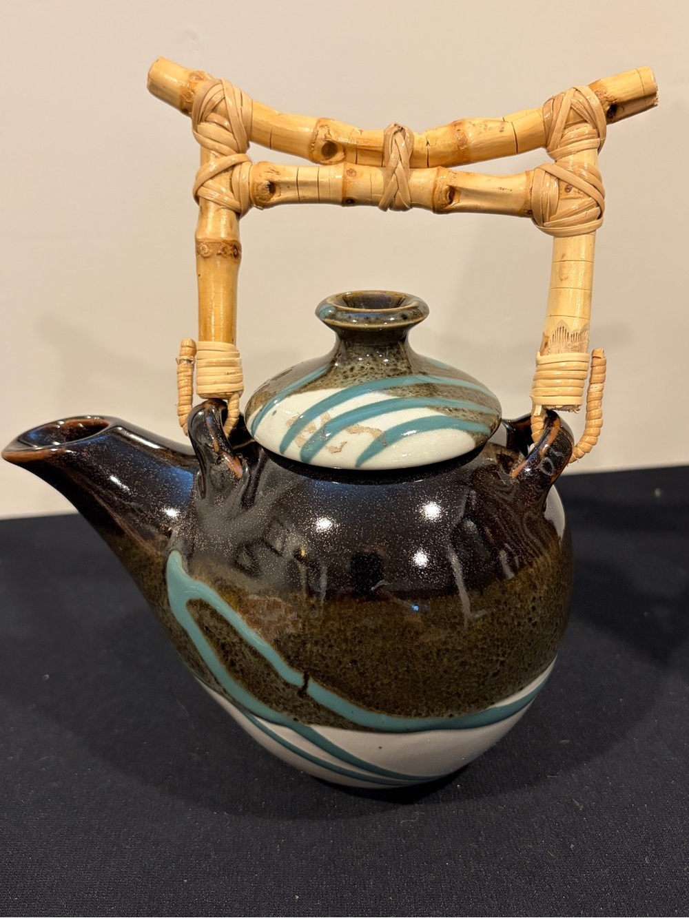 Vintage Signed teapot with a bamboo/rattan handle, speckled earth-tone glaze
